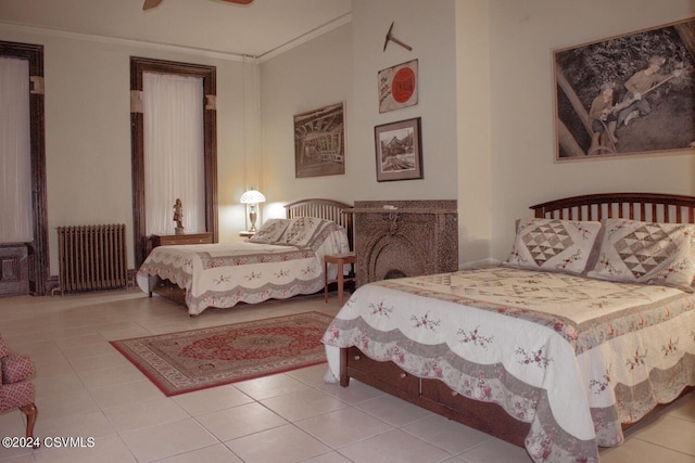 bedroom featuring crown molding, tile patterned flooring, and radiator