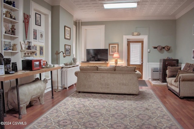 living room featuring ornamental molding and light hardwood / wood-style floors