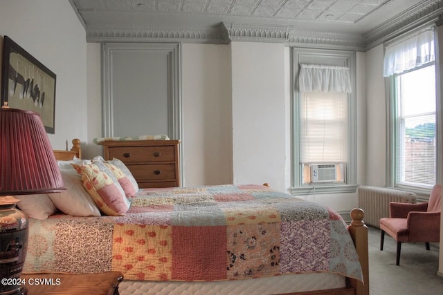 bedroom with cooling unit, carpet flooring, crown molding, and radiator heating unit