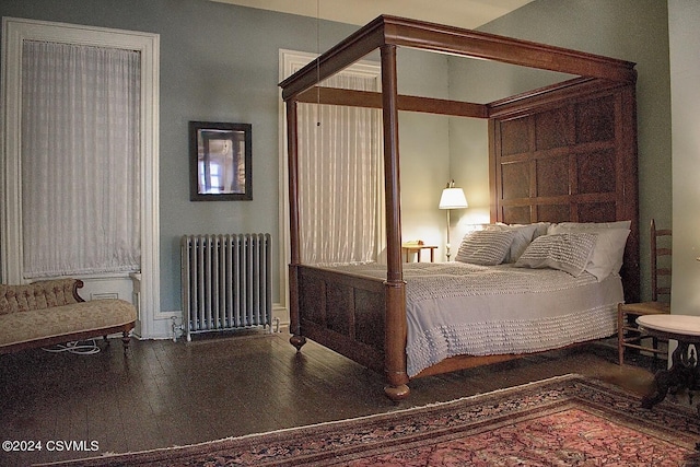 bedroom with radiator and wood-type flooring