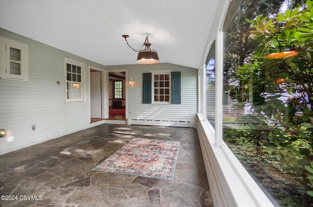 view of patio with a baseboard heating unit and a balcony