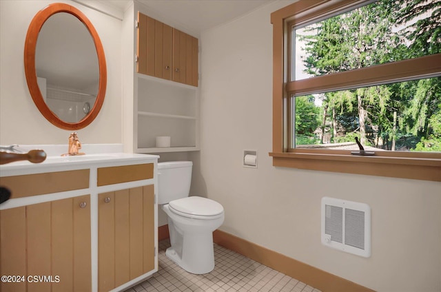 bathroom with toilet, tile patterned flooring, and vanity