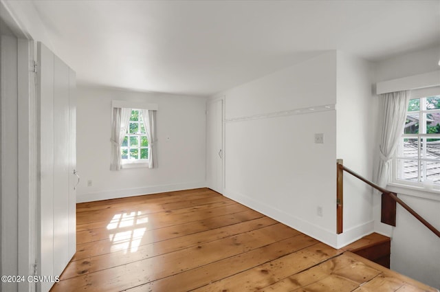 empty room featuring a wealth of natural light and light hardwood / wood-style floors