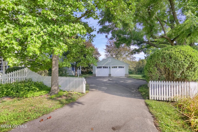 view of front of home with an outdoor structure and a garage