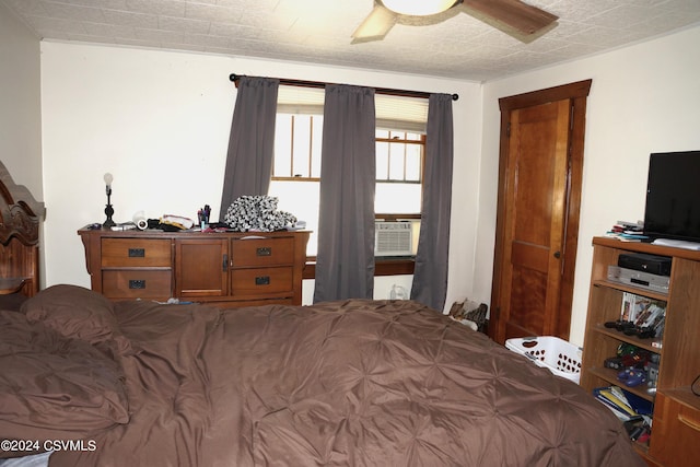 bedroom featuring cooling unit and ceiling fan