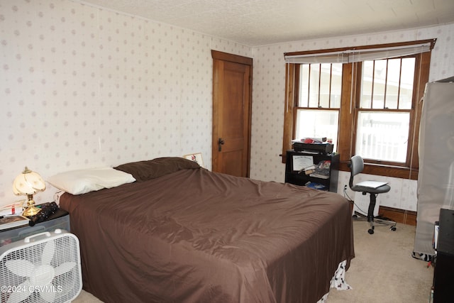 bedroom featuring light colored carpet and multiple windows