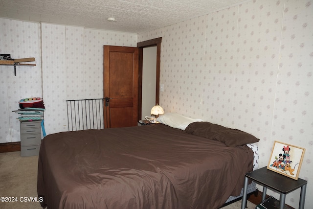 bedroom featuring carpet and a textured ceiling