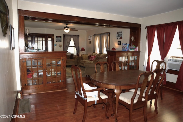 dining room featuring cooling unit, dark hardwood / wood-style floors, and ceiling fan