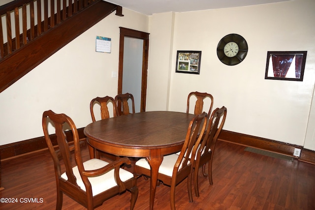 dining area with dark hardwood / wood-style flooring