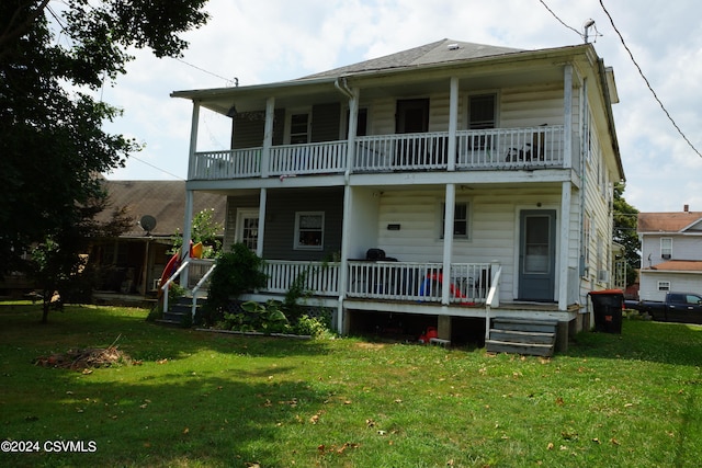 view of front of house with a balcony, a front lawn, and covered porch