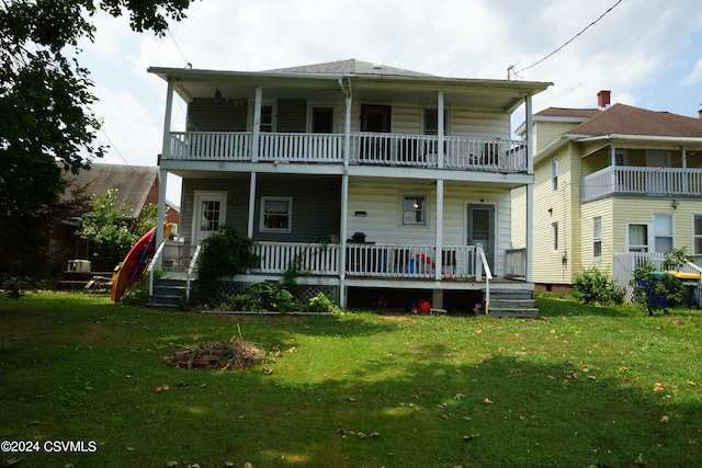 view of front facade featuring a balcony and a front yard