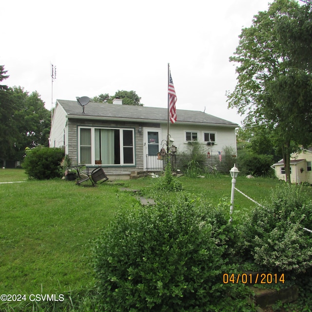 rear view of house with a lawn