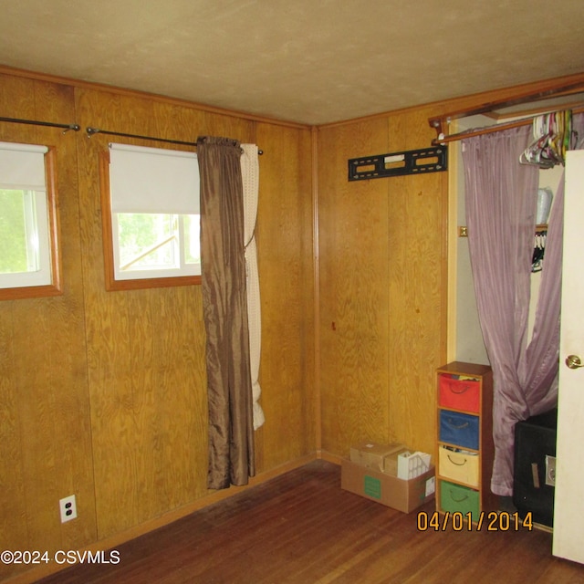 spare room with wood finished floors and wood walls