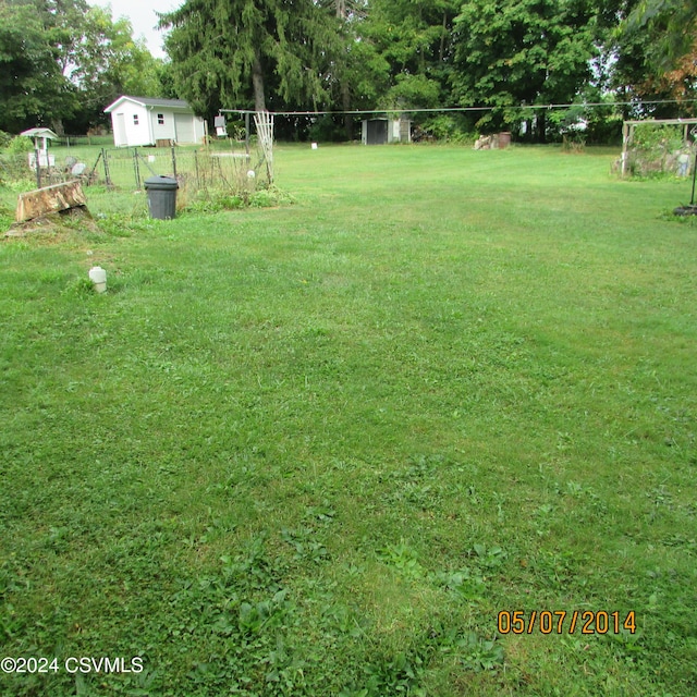 view of yard with a detached garage and fence