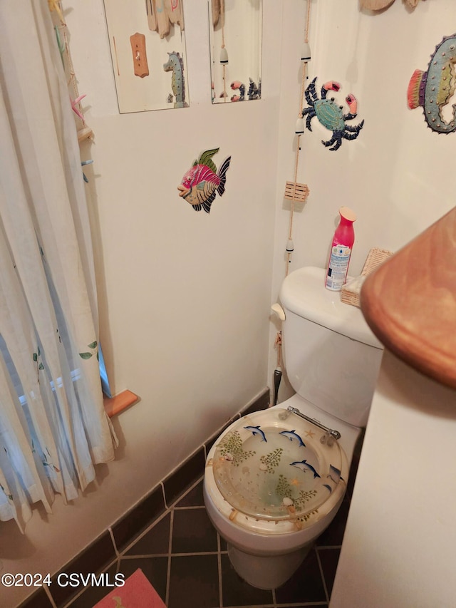 bathroom featuring tile patterned flooring and toilet