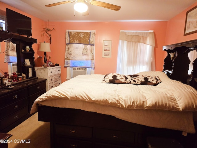 carpeted bedroom featuring cooling unit and ceiling fan