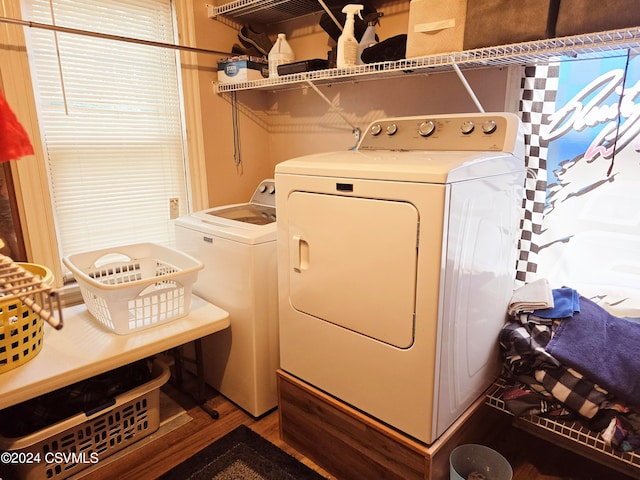 clothes washing area with wood-type flooring and washing machine and clothes dryer