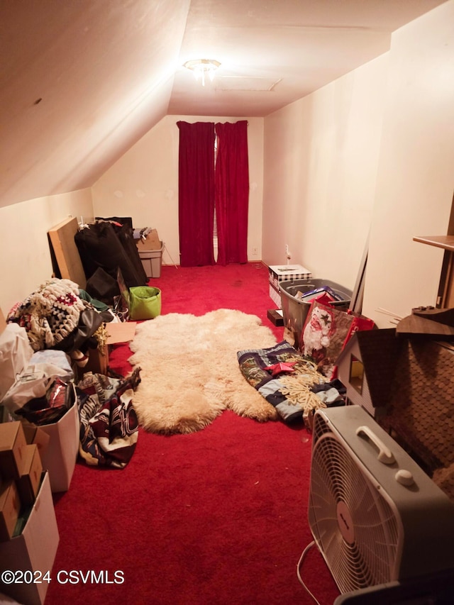 carpeted bedroom with lofted ceiling