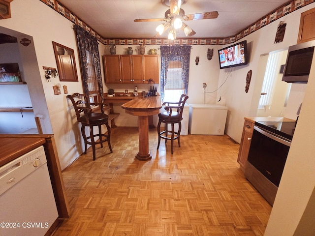 dining area featuring light parquet floors and ceiling fan