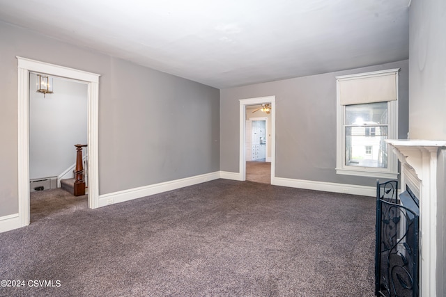 unfurnished living room with a baseboard radiator and carpet floors