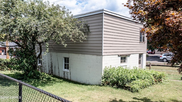 view of side of property with a lawn