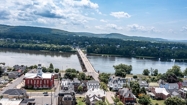 drone / aerial view featuring a water and mountain view