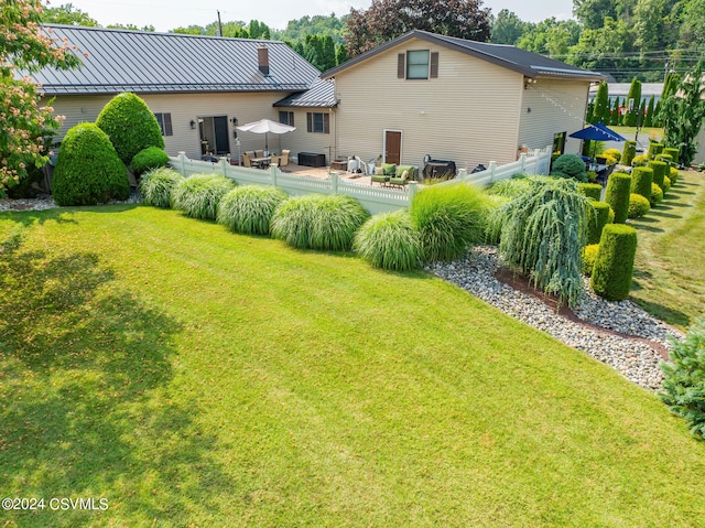 back of property featuring a yard