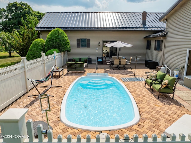 view of swimming pool featuring a patio area