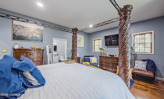 bedroom with hardwood / wood-style flooring and ensuite bathroom