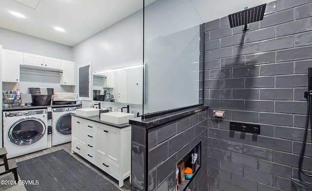 interior space with sink, washing machine and dryer, and light tile patterned floors