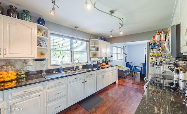 kitchen featuring sink, dark hardwood / wood-style floors, track lighting, and white cabinetry