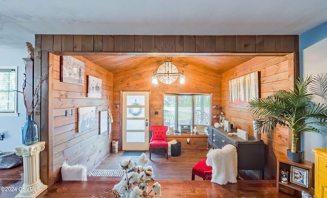 interior space with wood ceiling, wood walls, and hardwood / wood-style flooring