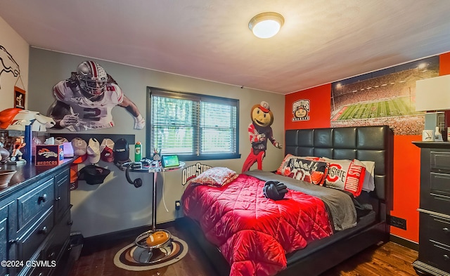 bedroom with dark hardwood / wood-style floors