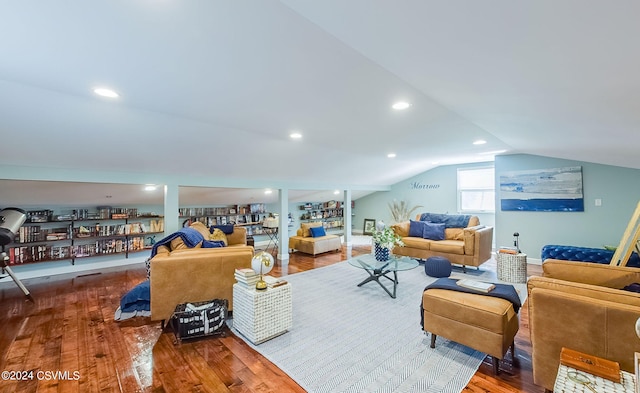 living room featuring dark wood-type flooring and lofted ceiling