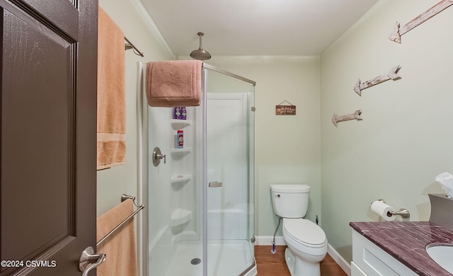 bathroom featuring vanity, toilet, hardwood / wood-style flooring, and an enclosed shower