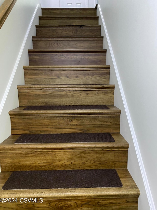 stairs with hardwood / wood-style flooring