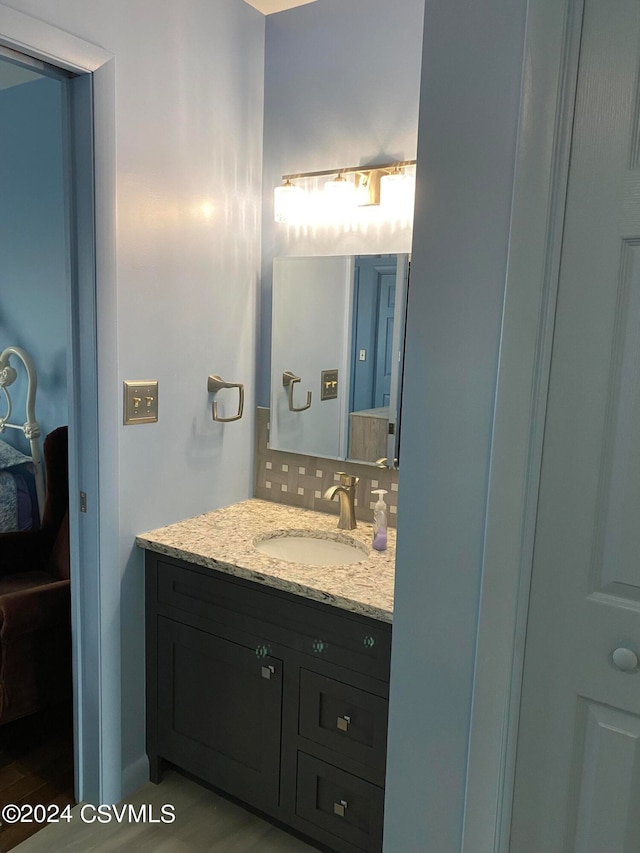 bathroom with vanity and wood-type flooring