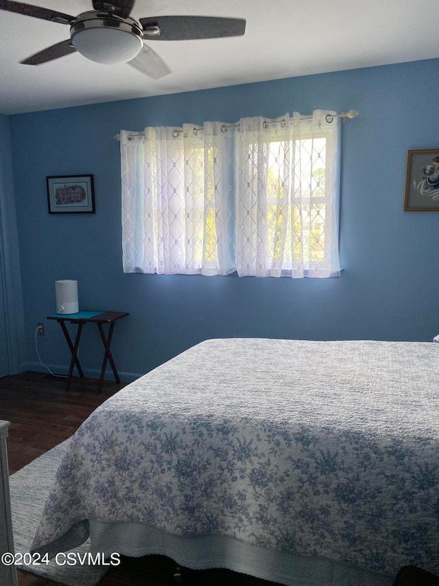 bedroom with hardwood / wood-style flooring and ceiling fan