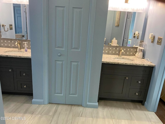 bathroom featuring tasteful backsplash and vanity