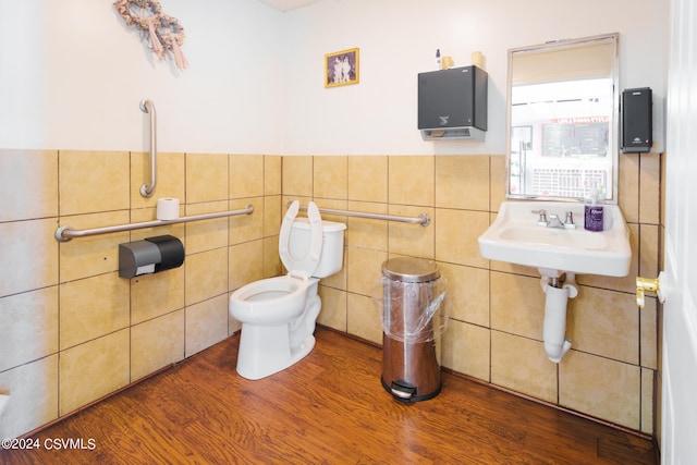 bathroom featuring tile walls, toilet, and hardwood / wood-style floors