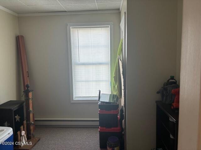 bedroom with carpet flooring, a drop ceiling, and a baseboard radiator