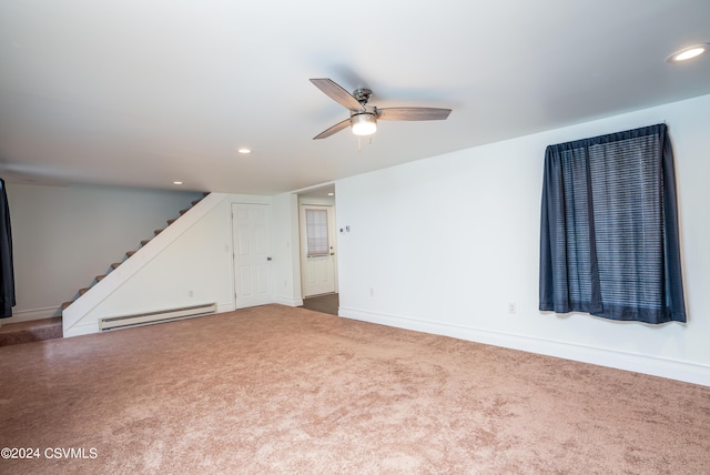 carpeted empty room featuring ceiling fan and baseboard heating