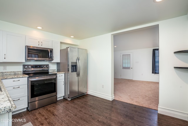 kitchen with white cabinetry, light stone countertops, dark hardwood / wood-style flooring, and stainless steel appliances