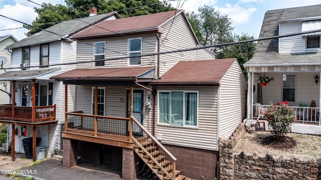 view of front of house with a porch and roof with shingles