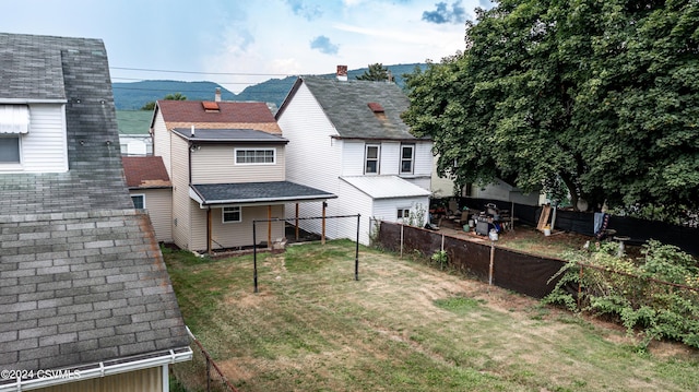 rear view of property featuring a lawn