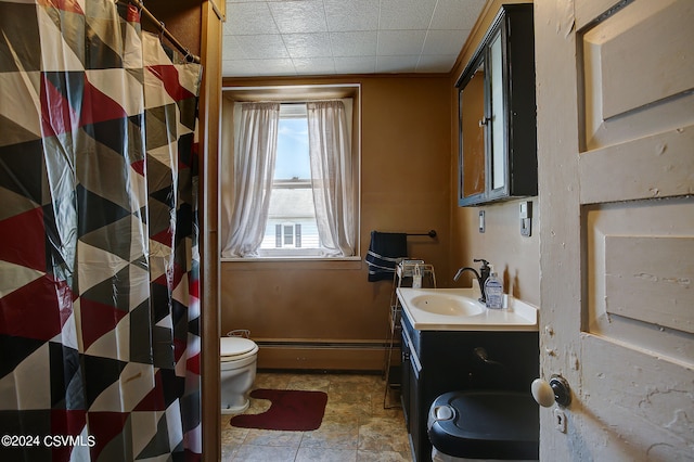 bathroom featuring tile patterned flooring, baseboard heating, toilet, and vanity