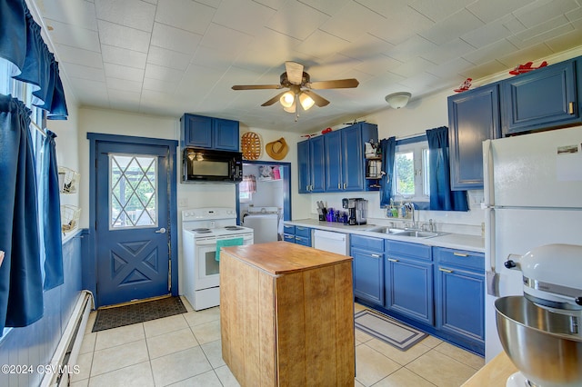 kitchen featuring light tile patterned floors, white appliances, sink, and ceiling fan