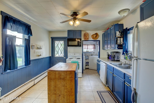 kitchen featuring blue cabinets, white appliances, and a baseboard radiator