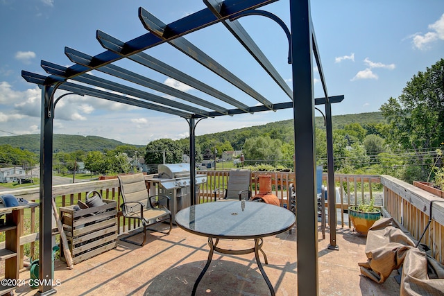 view of patio / terrace featuring a wooden deck and a pergola