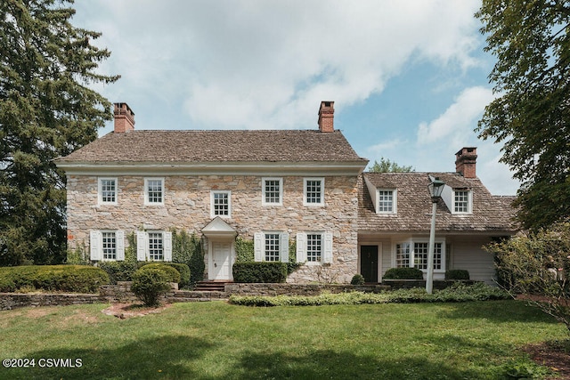 colonial home with a front yard